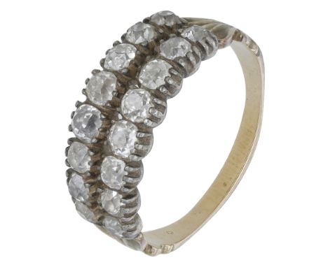 An early 19th century diamond ring, set with two rows of old brilliant-cut diamonds, between tapered shoulders to a reeded sh