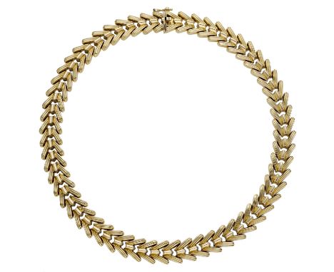 An 18ct gold collar necklace, composed of articulated reeded chevron links, stamped ‘750’, Egyptian assay mark, signed ‘KAZAN