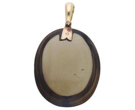 A large 19th century smoky quartz pendant, the oval smoky quartz cabochon with a tapered gold bale, quartz dimensions 55 x 45