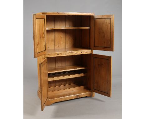 A golden oak drinks cabinet of pegged construction. With panelled doors, incorporating a slide and two bottle drawers. Royal 