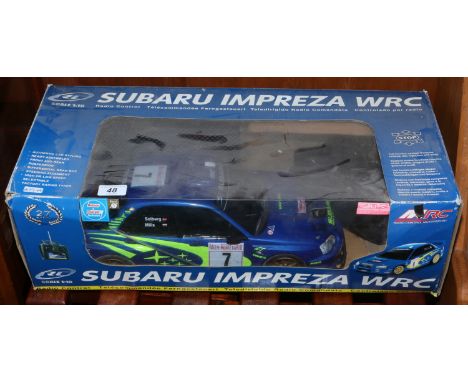 A boxed 1:10 scale radio controlled Subaru Impreza.