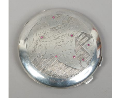 An Anglo Indian silver make up compact inset with rubies and chased with a map of India.