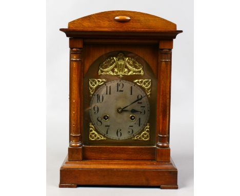 A German eight day mantle clock housing a Junghans movement and striking on a gong, along with a cased pair of Tasco zip bino