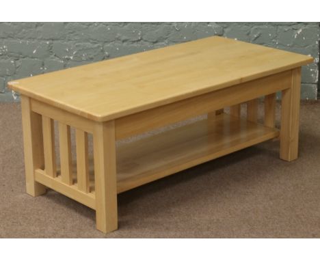 A two tier hardwood coffee table with magazine shelf.