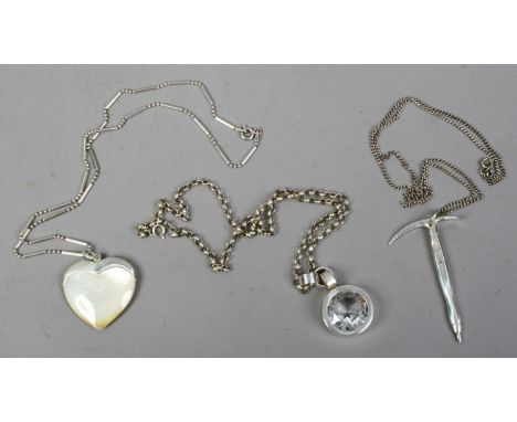 Three silver pendants on chains including a novelty example formed as a chiming axe.