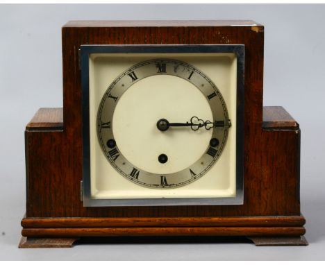 An Art Deco oak cased eight day Westminster mantel clock.