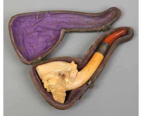 A Meerschaum pipe in case carved in the shape of a Turks head.