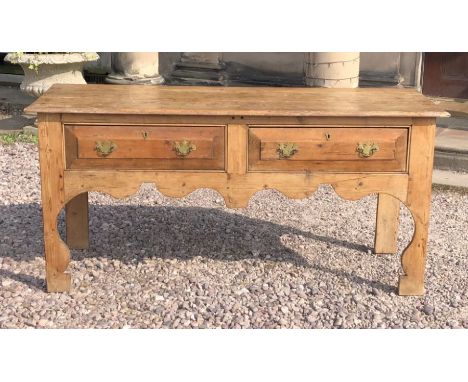 A 19th century pine sideboard, oak rectangular top above two frieze draws with chippendale style brass handles, shaped apron 