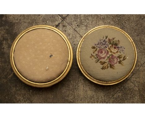 Two gilt circular foot stools, one with a tapestry top the other upholstered fabric, one raised on bun feet the other bracket