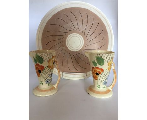 A Poole pottery charger, deep peach colour central ground decorated with alternating black and light coloured pattern, diamet