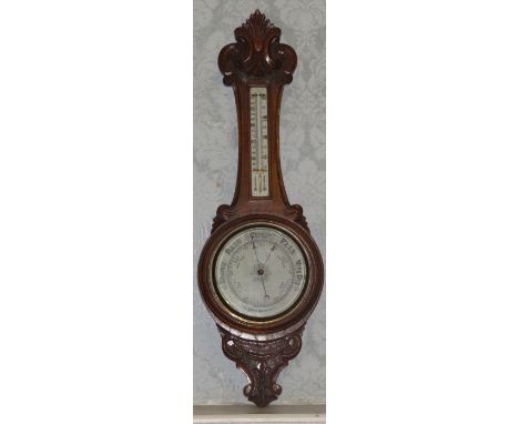 A Victorian aneroid barometer/thermometer in foliate scrolling oak frame, 88cm high