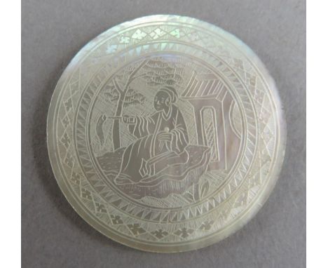 A nineteenth century Chinese mother of pearl engraved gaming token. 2.8cm wide.&nbsp;