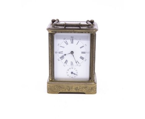 A brass mounted carriage clock, roman numerals, with a second smaller dial, florally chased design with a curved carrying han