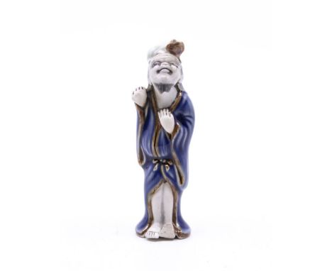 A late nineteenth century porcelain netsuke representing Gama Sennin. 8cm tall. Some minor damage. 