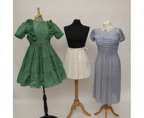 A Teddy Tingling pleated tennis skirt, the underskirt is of broderie anglais, metal zip, 1953; a child's blue floral dress, t