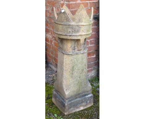 an architectural chimney pot with crown finial