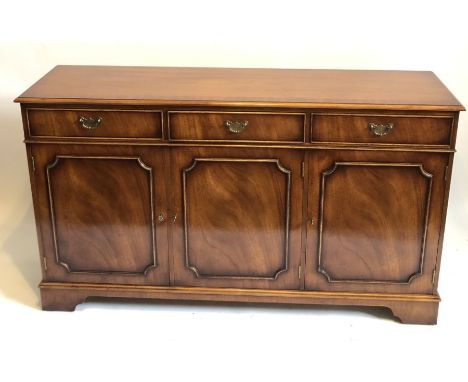 A 19th century style mahogany sideboard, crossbanded top with moulding, three frieze draws with brass handles above three cup