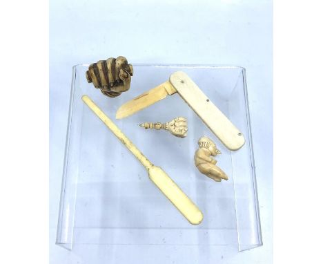 A collection of 19th century ivory items comprising:- a fist cane handle c.1880's, a smaller fist, an ivory handle and bladed