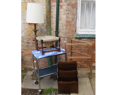 A standard lamp with tripod base, a chrome two tier tea trolley, a two division magazine rack, a footstool and a folding clot