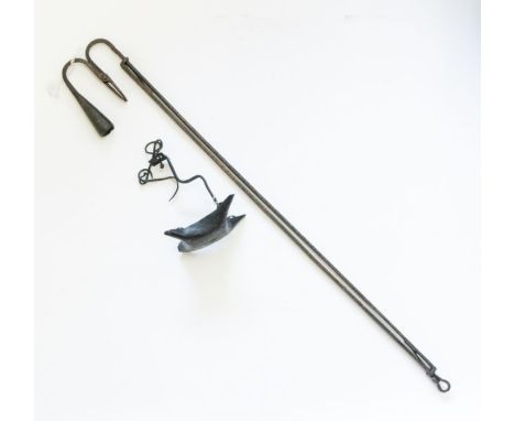 A wrought iron hanging rush light and candle holder together with a wrought iron fish oil lamp, both 18th century. (2)