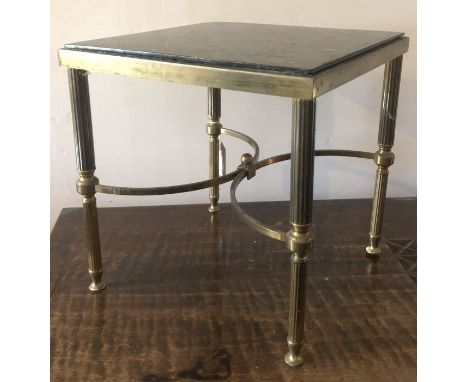 A late 19th century Louis XV style brass and glass topped stool, the glass top raised on fluted column legs terminating in pa