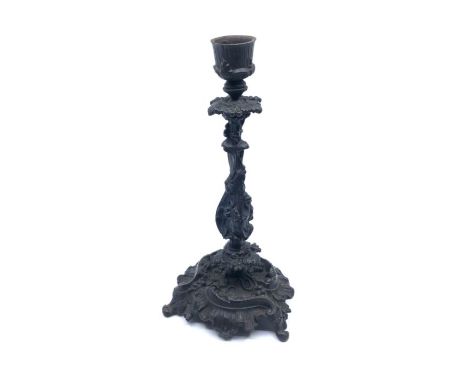 A 19th century painted cast iron candlestick floral cast column with floral base on three feet 24cm tall&nbsp;