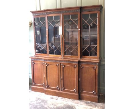 A large late Victorian mahogany bookcase, moulded cornice with pierced carved top band above four astragal doors enclosing th