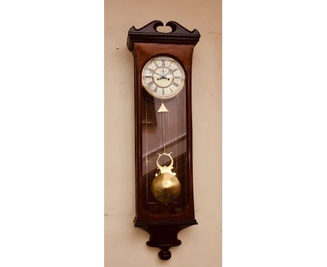 A 20th Century mahogany frame Vienna decor wall clock, swan neck broken pediment, above an arch glazed inlay enclosing an ena