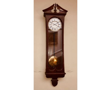 A late Victorian mahogany Vienna wall clock, circa 1900, broken pediment centred with a campaign finial on a moulded cornice,