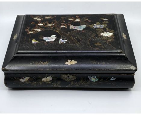 A 19th century Chinoiserie lacquered box with mother of pearl marquetry inlay, the lid with moulded edges with mother of pear