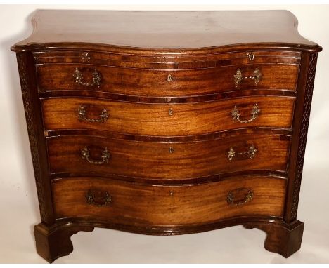 A George III mahogany serpentine dressing chest, circa 1760, in a manner of Thomas Chippendale, crossbanded top with a slight