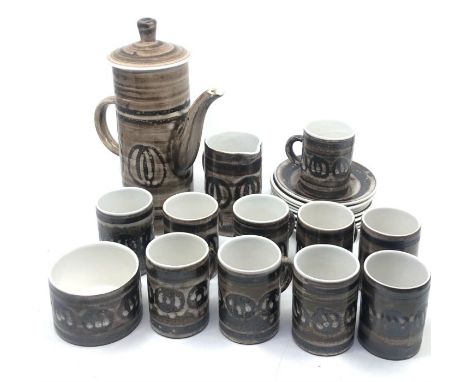 A 1970's coffee set by Cinque Ports Pottery Ltd., the Monastery Rye Design, comprising:- a coffee pot and lid, ten cups, nine