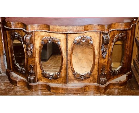 A Victorian burr walnut serpentine credenza, circa 1860, caddy top, above a two panel doors with oval looking glass inlay, fl