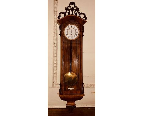 A Victorian and later rosewood, mahogany and satinwood strung Vienna wall clock, foliage carved top mounted an arch cornice, 
