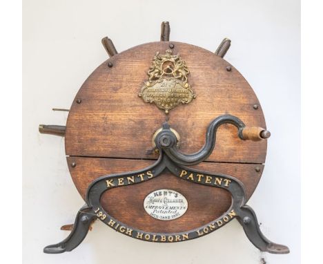 A Kent Patent knife cleaner, patented 1870-1887, constructed from a circular wooden barrel with iron and brass mounts. 42 cm 
