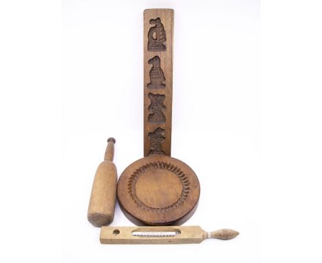 Four items of treen comprising:- a shortbread mould, another mould, a wooden pestel and a milk thermometer (4)