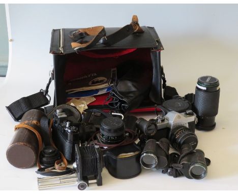 A case of photographic/optical equipment including pentax SLR camera, tele photo lenses extensions, karl zess binoculars, ope