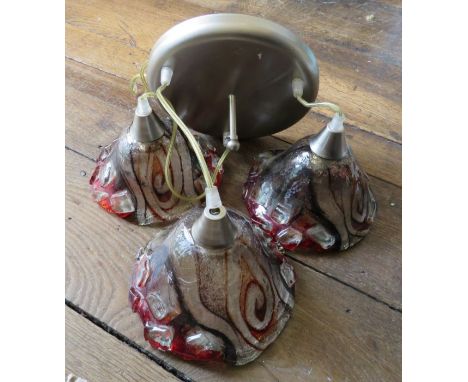 A decorative hanging light with three coloured and moulded shades. Wired for electricity. (1)Condition: Damage to one shade. 