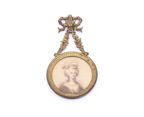A 19th century portrait miniature print of Marie Antoinette, in a circular fame mounted with gilt swag decoration 14cm high