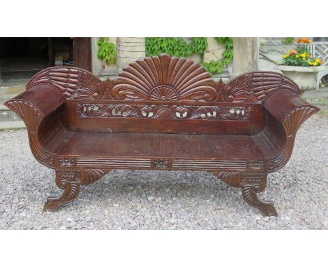 An Anglo indian hardwood sofa, 19th century, the arched back with floral decoration, scroll arms, outcurved legs, 190cm wide