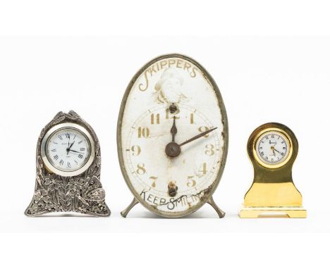 A "Skippers" alarm clock, the enamel dial inscribed "Skippers, keep smiling", a brass miniature balloon shaped clock retailed