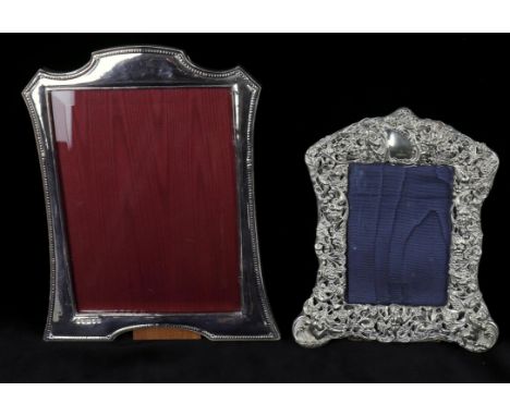 
	
		An Edwardian silver photo frame, shaped rectangular die-stamped and pierced with putti birds and vines, Birmingham 1901,