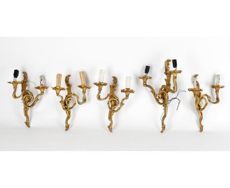
	
		A set of five gilt metal twin light wall lights in Louis XV style, modern, comprising two pairs and a single light, larg