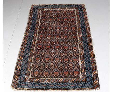 
	
		Three rugs including an antique Caucasian Kuba small rug, black/brown field with repeating flowerhead trellis design, ha