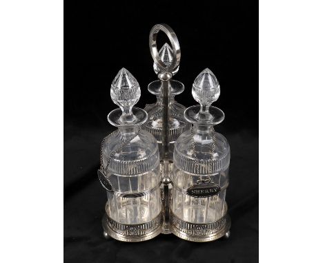 
	
		A late Victorian silver plated decanter frame, of trefoil form with reeded central handle, the three decanters flute cut