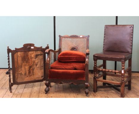A 1940's oak armchair, oak bobbin turned leather chair and an embroidered firescreen