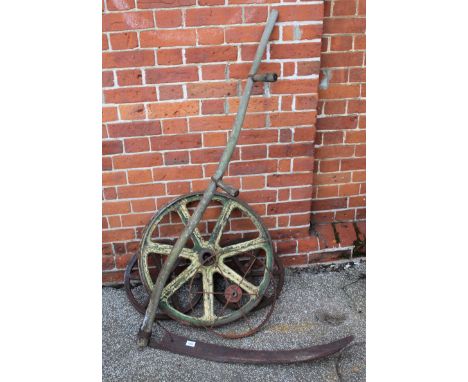 Assorted vintage metal cartwheels and a vintage scythe