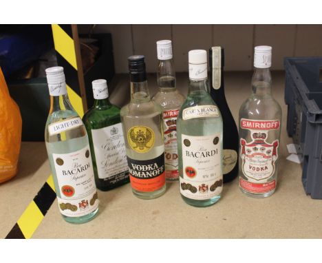 A selection of seven mixed spirits including Alfred Lambs Rum, three bottles of vodka, two Bacardi, and a Gordons Gin