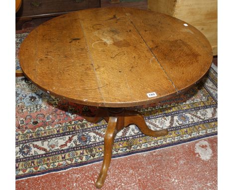 A19th century oak tilt top table on a pedestal tripod base.92cm diam 