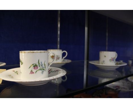 A set of six Meissen (outside decorated) coffee cans and saucers, blue crossed swords and cancellation marks (af) 